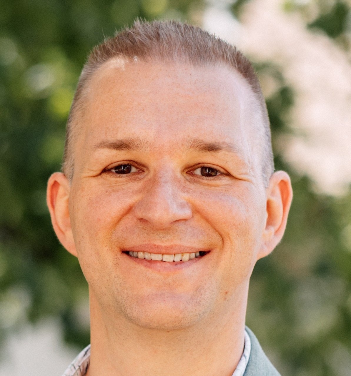 A simplistic illustration of a mans face in a flat, two-dimensional style.