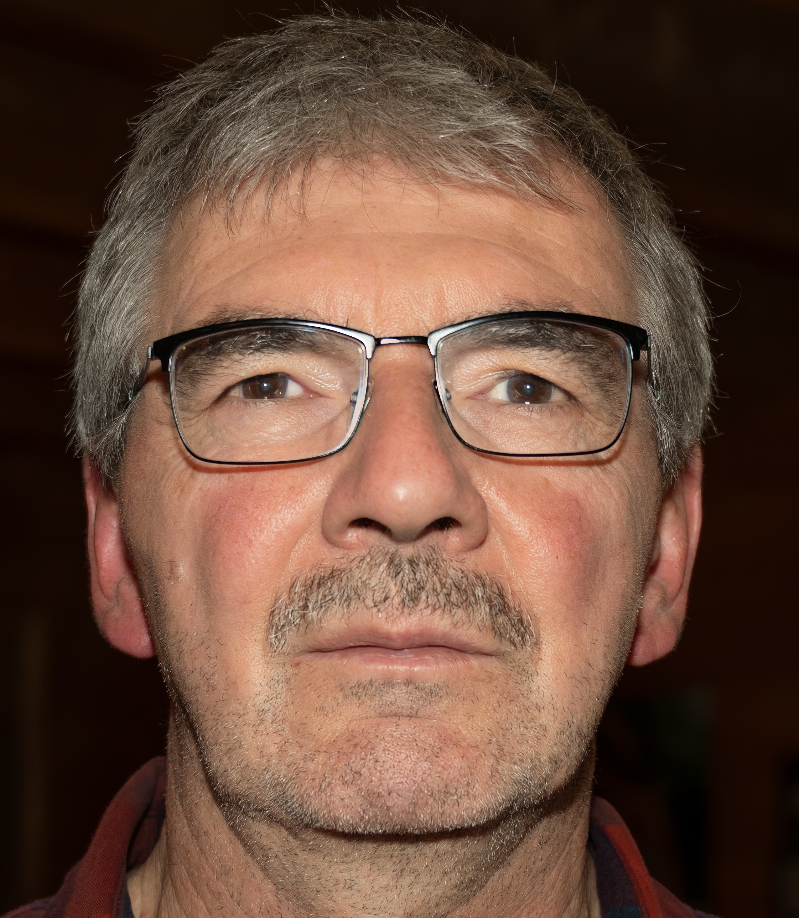 A simplistic illustration of a mans face in a flat, two-dimensional style.