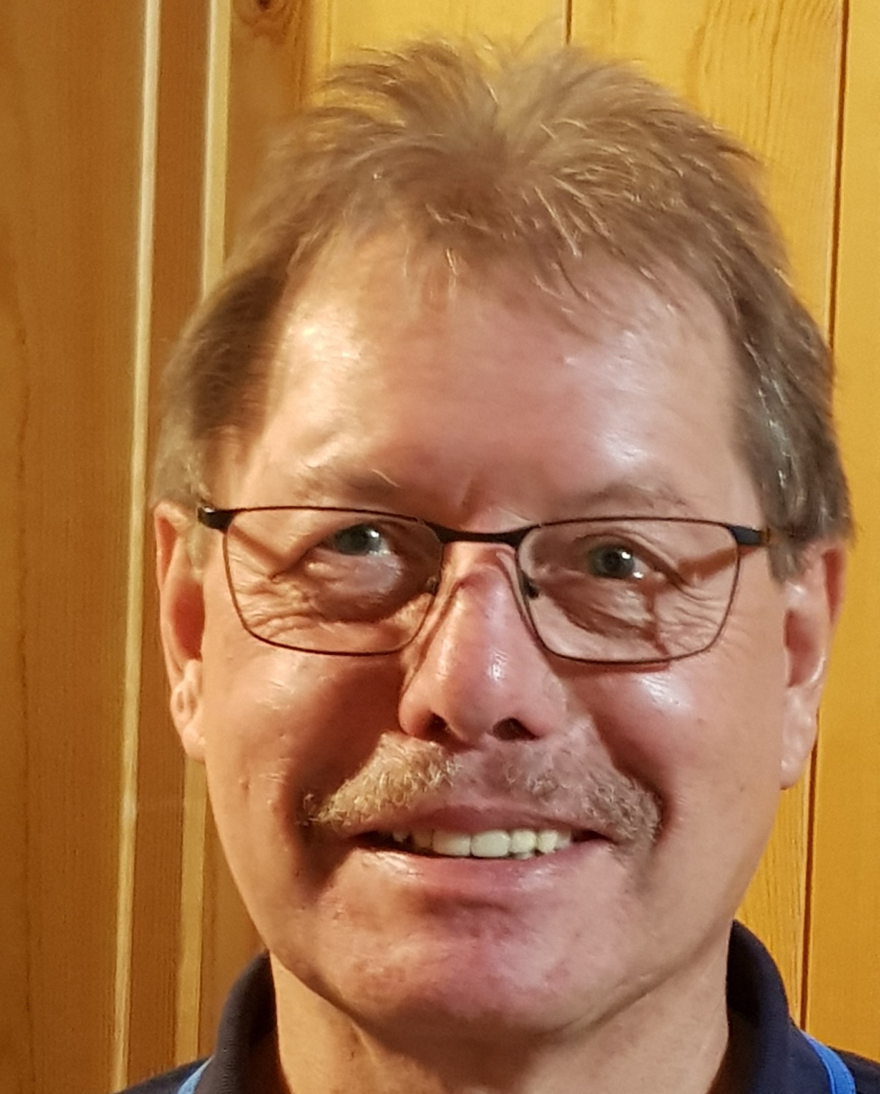 A simplistic illustration of a mans face in a flat, two-dimensional style.